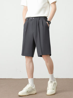 Men's dark gray chino shorts with pleats and a loose fit.