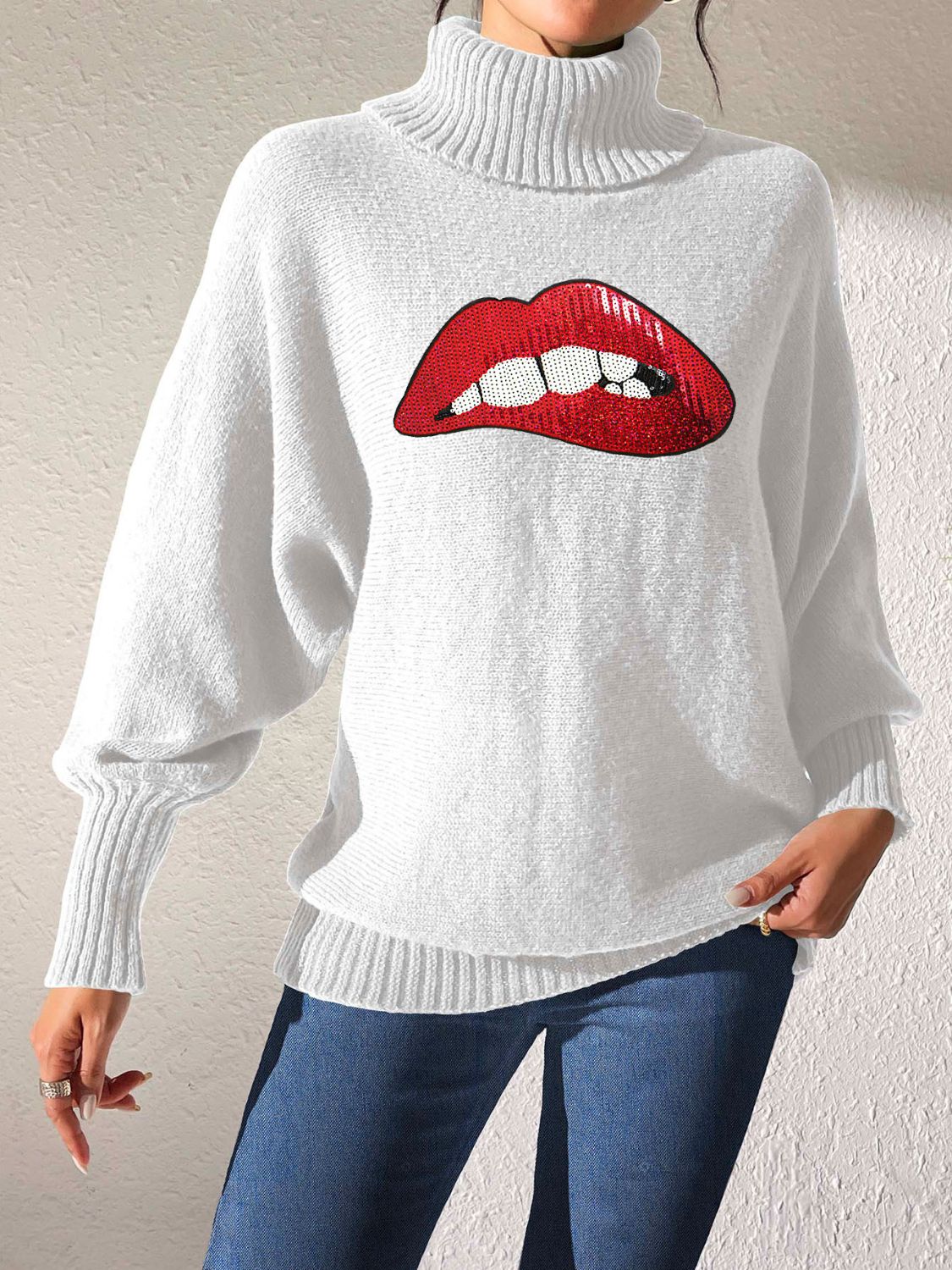White turtleneck sweater with sequin red lips graphic and balloon sleeves.