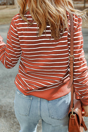 Nautical stripe crewneck sweatshirt in red orange with white stripes, casual long sleeves.