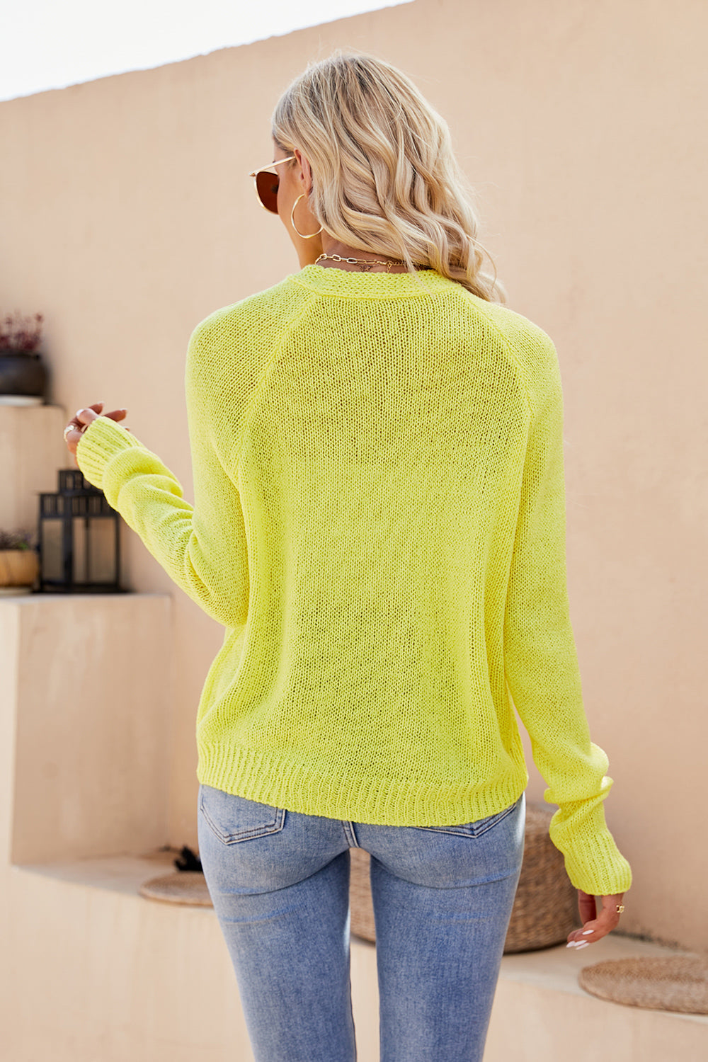 Banana yellow acrylic knit cardigan with raglan sleeves and button detail.