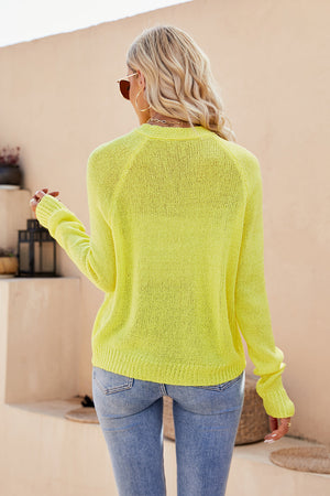 Banana yellow acrylic knit cardigan with raglan sleeves and button detail.