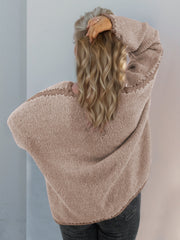 Oversized knit cardigan in tan with contrast stitching detail on shoulders and cuffs.