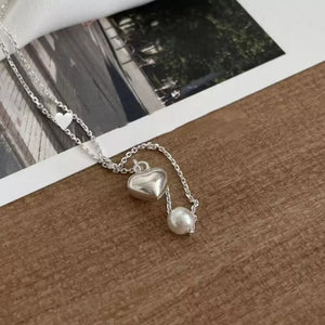 Silver necklace with heart pendant and pearl accent