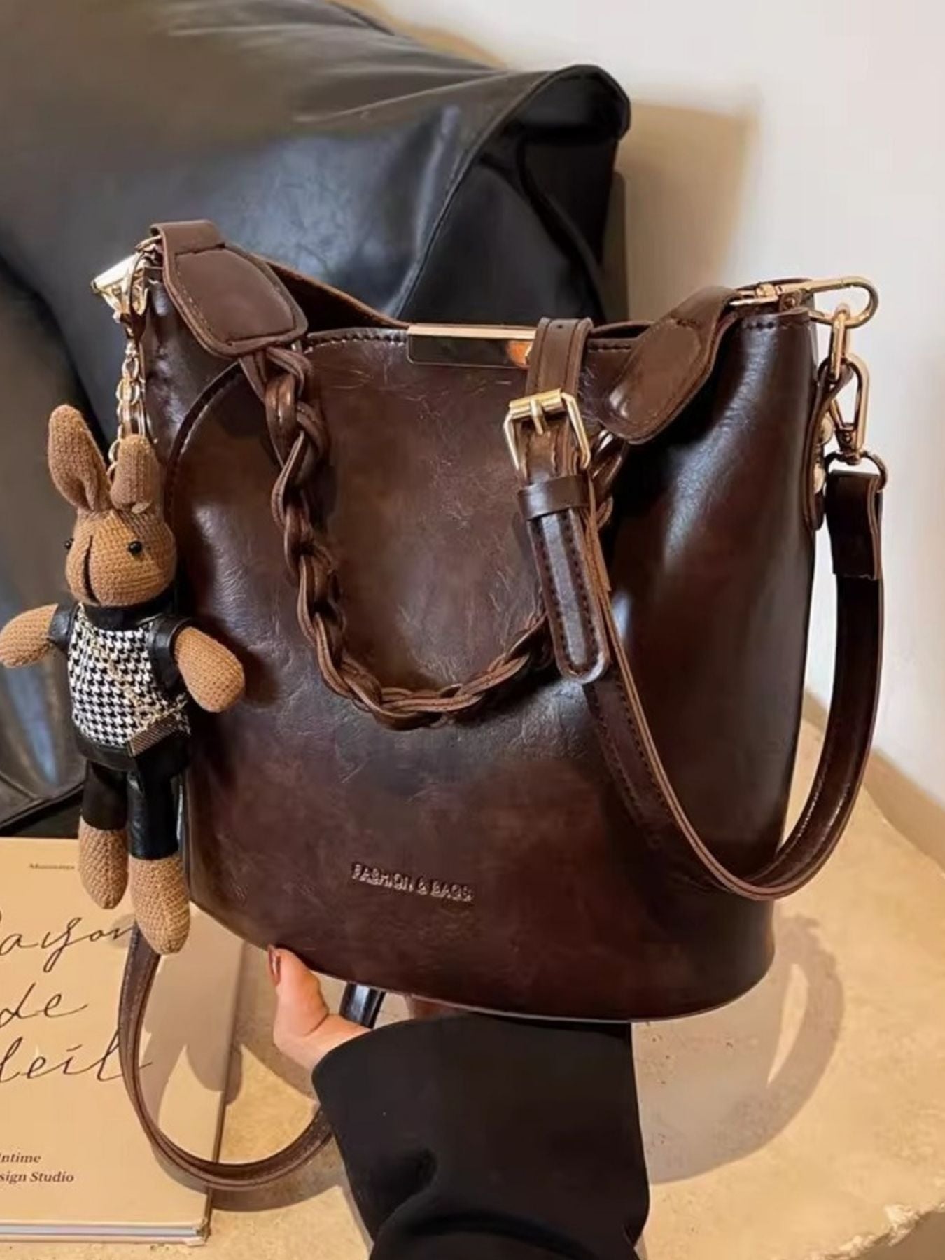 Brown braided bucket crossbody bag with bunny charm