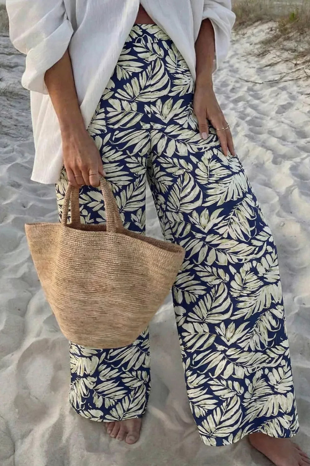 Navy leaf print maternity trousers with a high waist and wide leg, made of cotton.