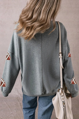Dark gray sweatshirt with football sequin embellishments on sleeves.