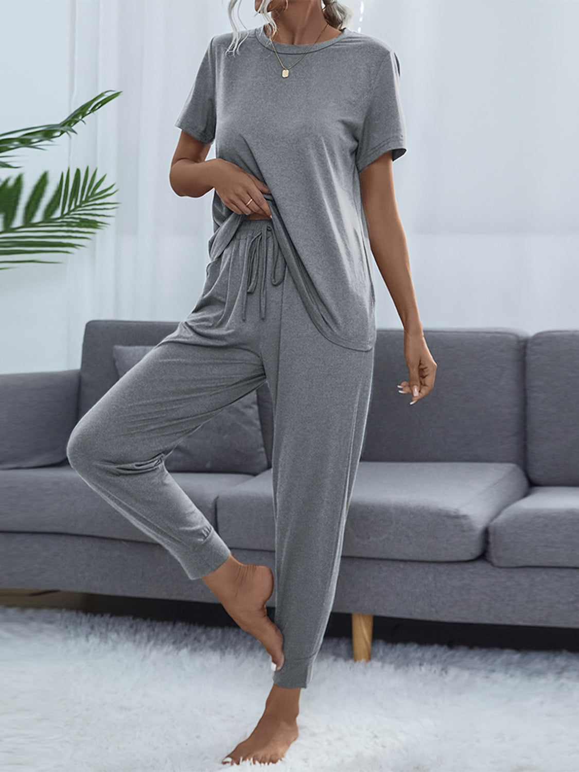 Relaxed-fit grey tee and jogger set with drawstring waist and cuffed ankles.