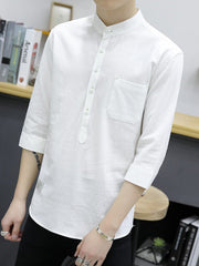 White cotton shirt with button detail, mandarin collar, chest pocket, and 3/4 sleeves.