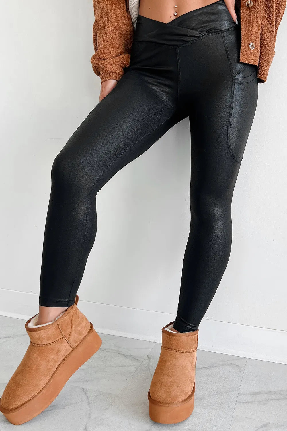 Black faux leather leggings with textured finish and pockets
