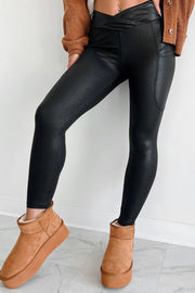 Black faux leather leggings with textured finish and pockets