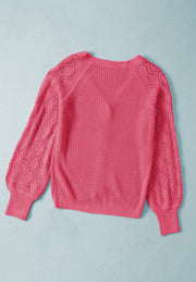 Diamond-cut sleeve knit cardigan in hot pink with a V-neck and ribbed cuffs.