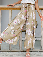 Floral wide-leg palazzo pants with high slits and a self-tie waist.