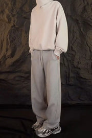 Relaxed-fit lounge trousers in dark gray with a drawstring waist and side pockets.