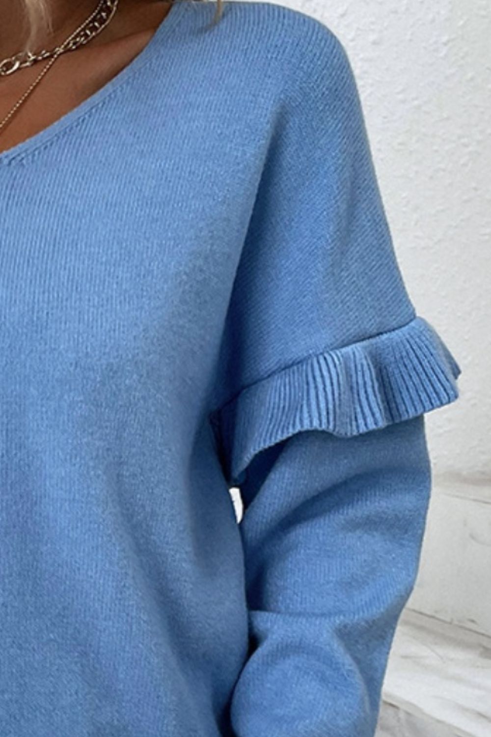 Blue knit v-neck pullover sweater with ruffled sleeve detail