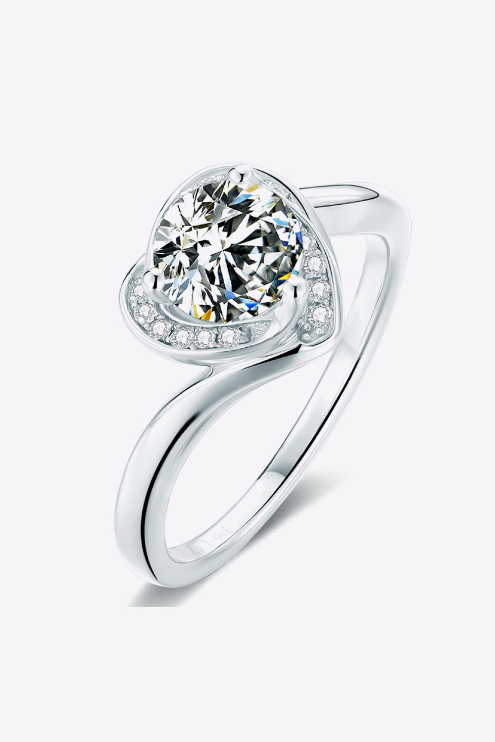 Silver moissanite ring with a heart-shaped halo and round center stone.