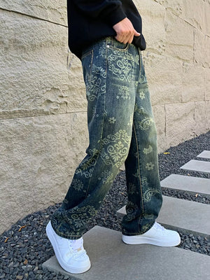 Men's dark wash jeans with heritage floral print and a relaxed fit.