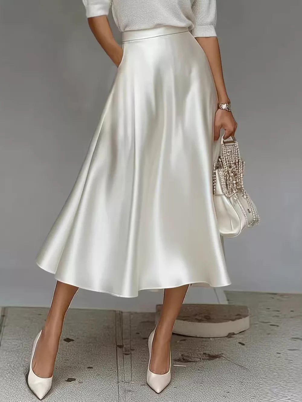 White satin A-line midi skirt with pockets, flowing silhouette