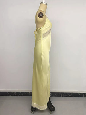Yellow satin midi slip dress with lace trim and side slit detail.