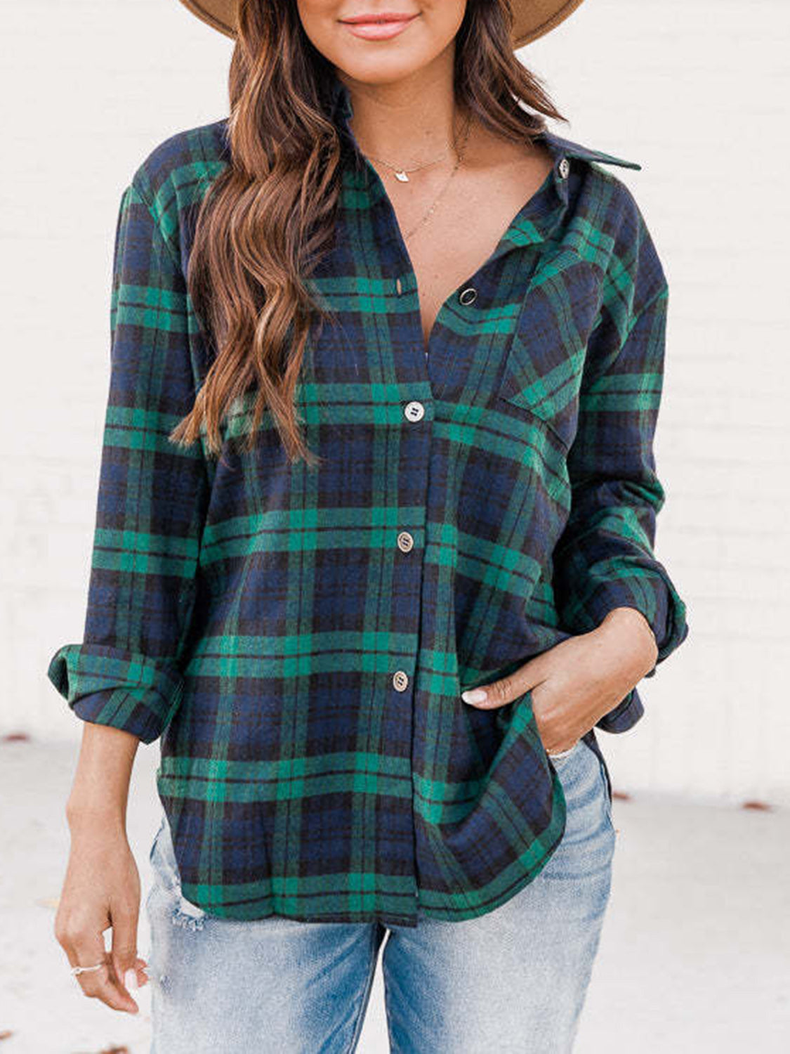 Relaxed fit plaid button-down shirt in navy and green with rolled sleeves.
