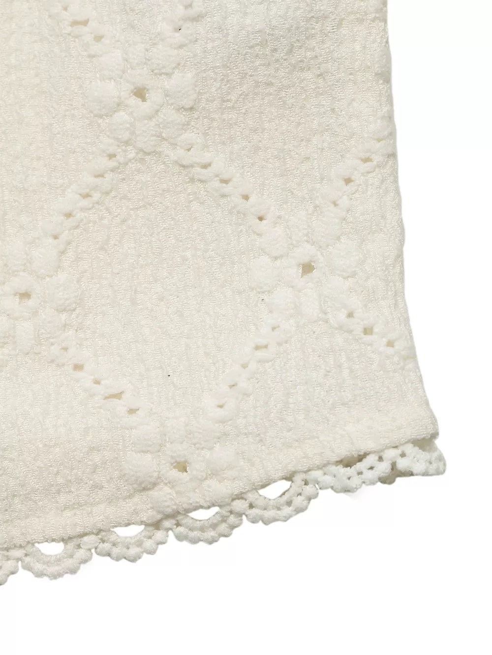 Textured white maternity shirt with diamond pattern and lace trim detail.
