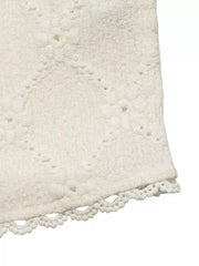 Textured white maternity shirt with diamond pattern and lace trim detail.