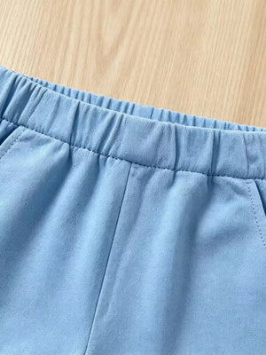 Baby blue cotton shorts with elastic waistband and pockets.