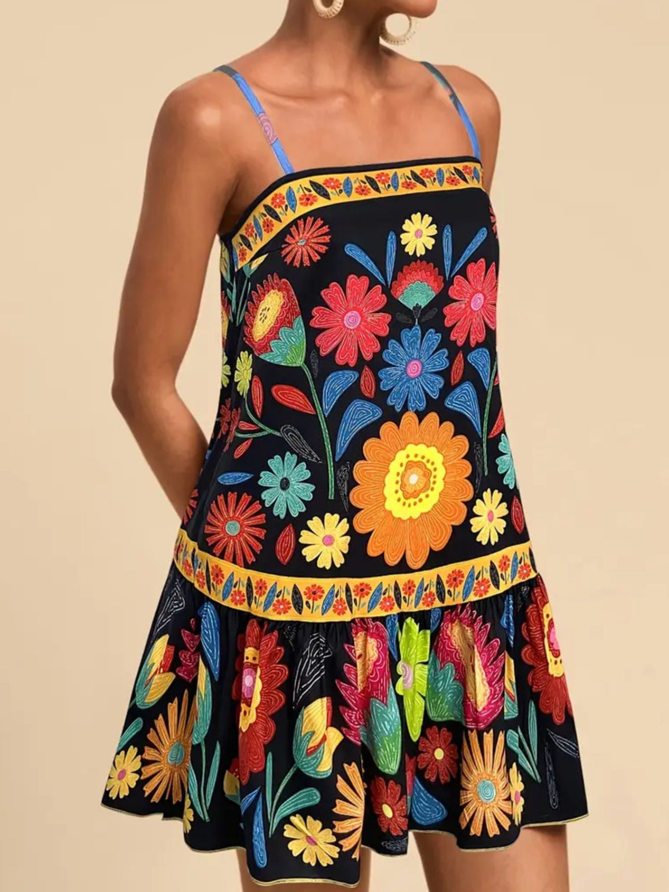 Black mini dress with vibrant floral print, square neckline, and ruffled hem.