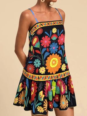 Black mini dress with vibrant floral print, square neckline, and ruffled hem.