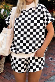 Black and white checkerboard print shorts with a cream waistband.