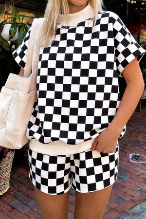 Black and white checkerboard print shorts with a cream waistband.