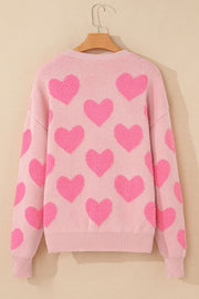 Blush pink knit sweater with allover textured bright pink heart motif.