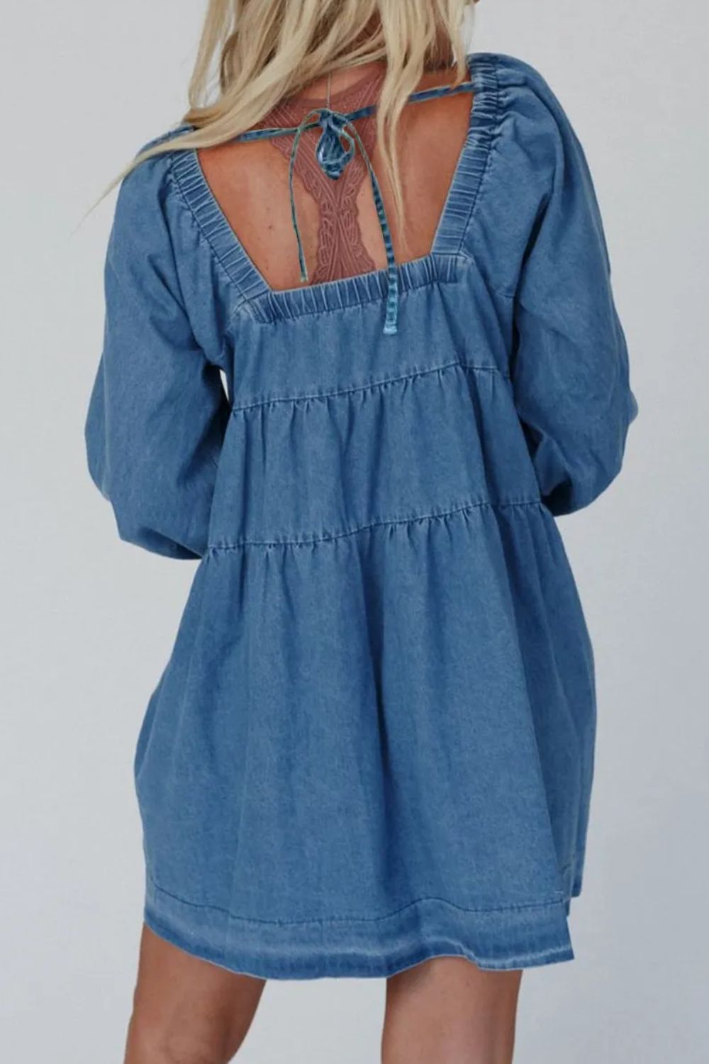 Tiered denim mini dress with square neck and tie back detail.