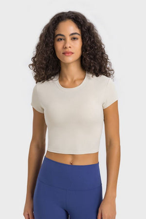 Ribbed ivory crewneck crop top with short sleeves.