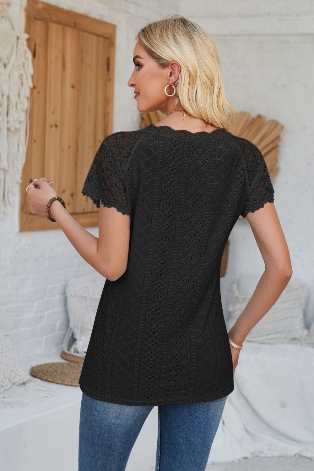Black eyelet raglan blouse with lace short sleeves and scalloped neckline.