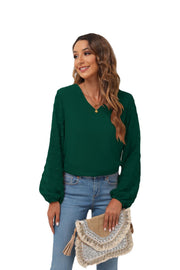 Forest green V-neck blouse with pom-pom textured balloon sleeves.