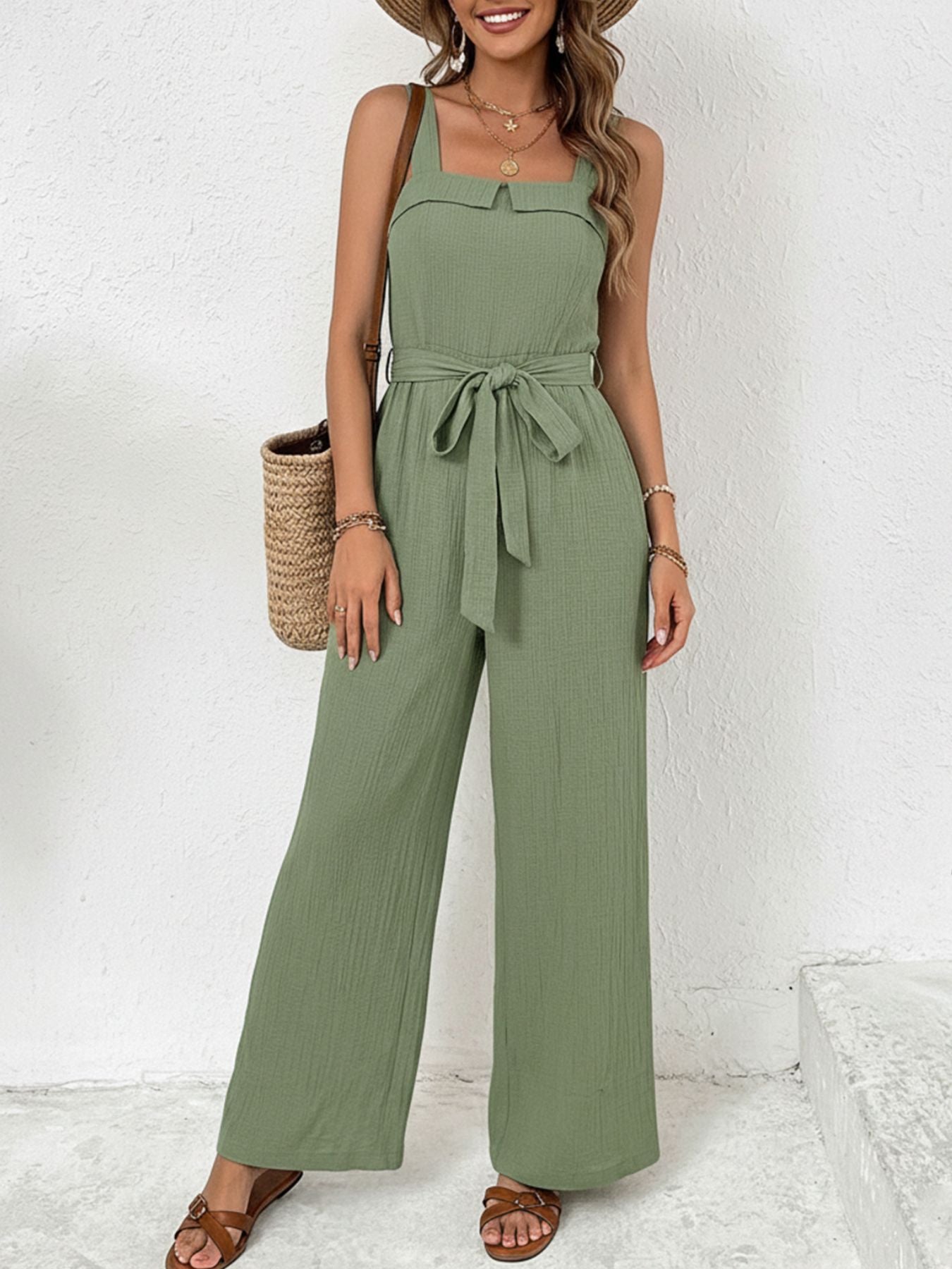 Green crinkled tie waist wide leg maternity jumpsuit with square neckline.