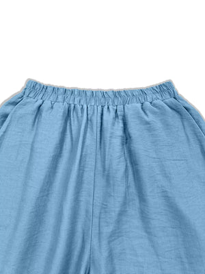 Sky blue wide-leg trousers with elastic waistband and textured fabric detail.