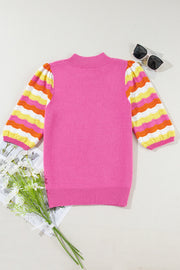 Colorblock puff sleeve sweater in fuchsia pink with striped sleeves and mock neck.
