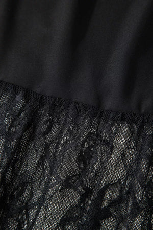 Black lace maxi dress detail with sheer lace overlay and smooth fabric.