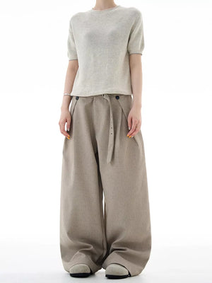 Khaki plus size wide-leg sweatpants with belt and button details.