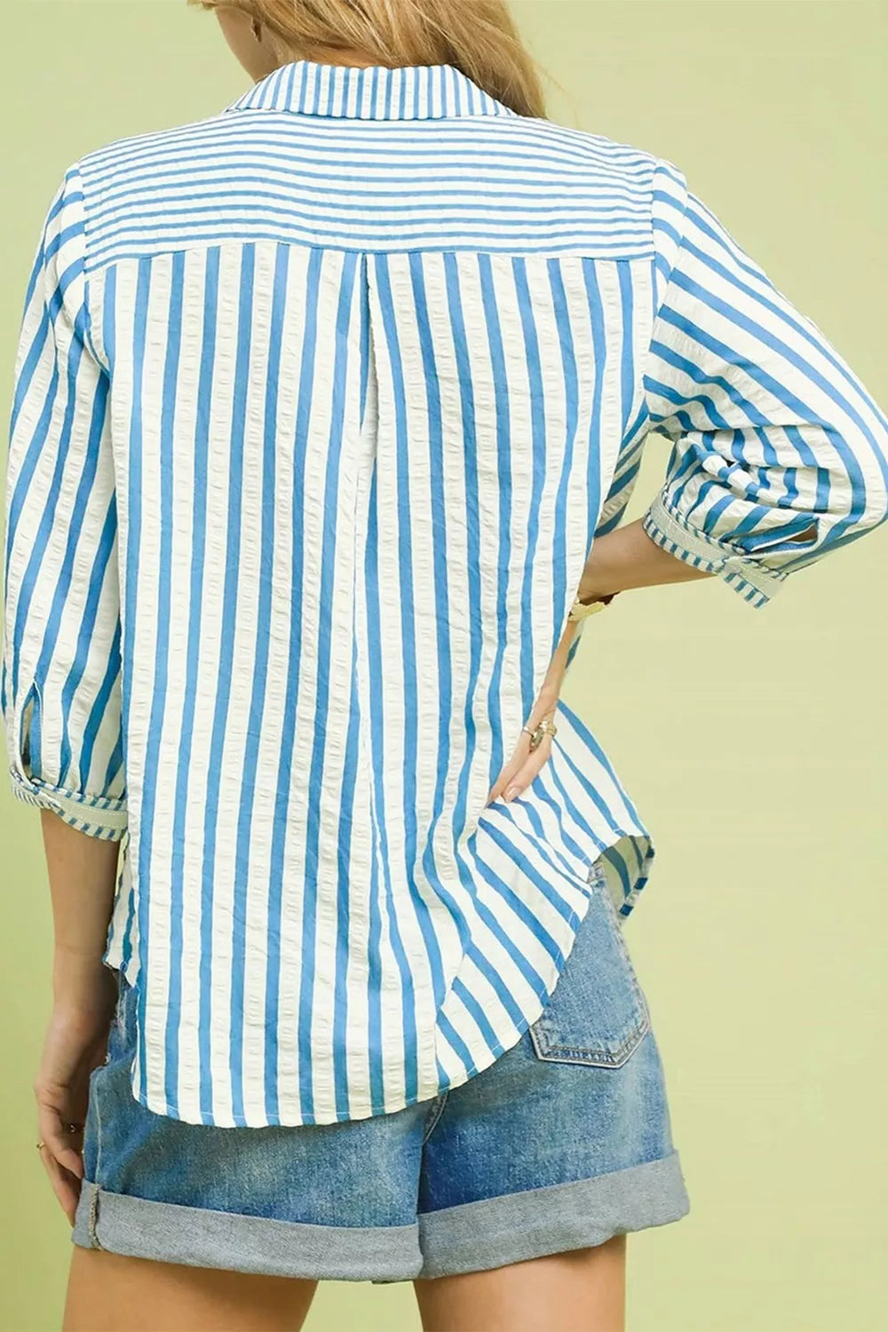 Classic blue and white striped cotton collared blouse with textured fabric and buttoned cuffs.