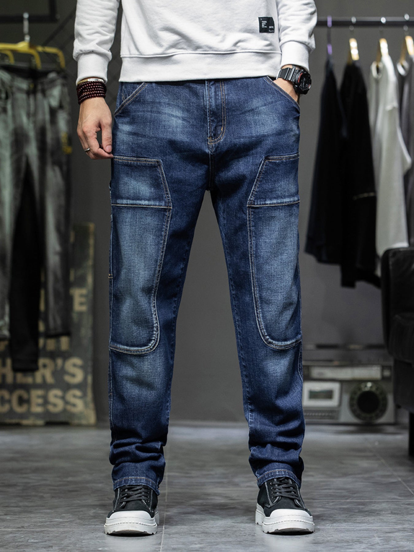 Men's dark blue 100% cotton cargo jeans with relaxed fit and utility pockets.