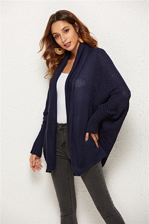 Textured cocoon knit cardigan in dark blue with batwing sleeves and open front.