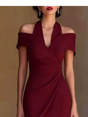 Sophisticated red asymmetrical midi dress with off-shoulder neckline and draped detail.