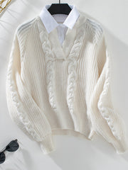 Cream cable knit V-neck sweater with blouson sleeves and a white collared shirt layered underneath.