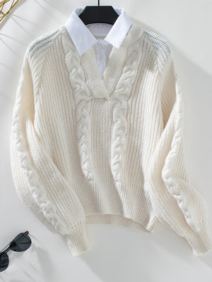 Cream cable knit V-neck sweater with blouson sleeves and a white collared shirt layered underneath.