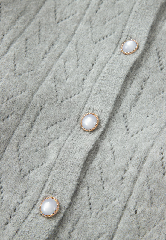 Gray lace-effect knit button-down cardigan with pearl buttons and diamond pattern.