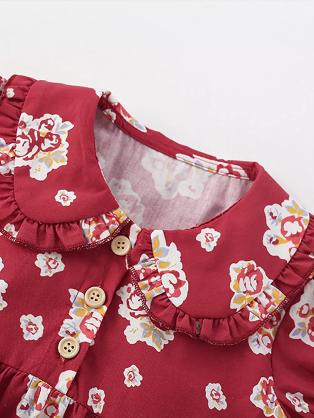 Baby dress with floral print, ruffle collar, and button front.