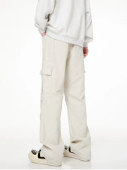 Men's loose fit cargo pants in creamy-white with multiple pockets.