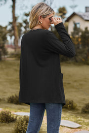Black textured open-front cardigan with pockets and long sleeves.